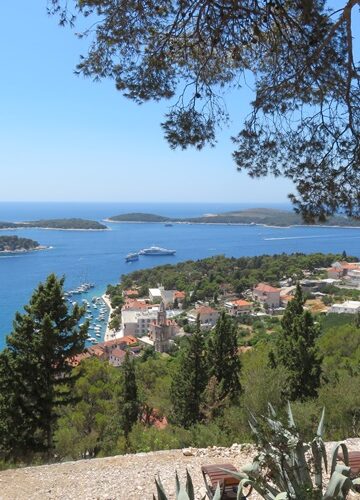 Located in the Adriatic Sea, the Island of Hvar is one of the most popular summer destinations in Croatia. It’s impressive to note that the tourism industry in Hvar started blooming more than one hundred and fifty years ago. Even today, people are seduced by this island’s charming fishing villages and the spectacular architecture throughout the island. Tourists keep coming back year after year. It is not just the history of the island and its incredible five UNESCO sites, but also its cultural heritage, which is celebrated throughout the seasons with various festivals. These festivals tend to revolve around the rich agricultural history including almond, lavender, olive, and wine production which make Hvar a place like no other. Read on for the ultimate guide to the Island of Hvar! History of the Island of Hvar The Island of Hvar may have gained popularity among tourists in the last couple hundred years, but its history dates all the way back to pre-historic times. Incredible ceramic pieces have been unearthed across the island, which prove human habitation during the Neolithic period. Later on, the ancient Greeks chose this island, the longest of the Croatian Islands, as their new home. Approximately 2,400 years ago, they were also the first to build an entire city on the island, which boasted fortified walls and became the settlement for more than one thousand inhabitants. Between the 15th and 18th century, the island of Hvar was under the rule of the Republic of Venice. But it was during the Austro-Hungarian empire when the island began to find prosperity through the growth of its successful fishing fleets, which sailed across the Mediterranean. It is this unique combination of several cultures and traditions which make the island of Hvar so vibrantly colorful and one-of-a-kind! From strolling down the ancient stone walls to exploring the unique Roman Villas, there is so much to do in Hvar. Wait no more; start planning your own ultimate trip to the Island of Hvar! What to Do: Explore Hvar Town As the largest city on the island, the city of Hvar has plenty to offer, and it is the best spot to begin your holiday adventure. Historic paradise, restaurant heaven, hiker’s wonderland, and party district are all accurate descriptions for this vibrant town. The history buffs can head all the way up to the top of the hill to reach the 15th century Fortica Fortress (Spanjola). Pay a visit at dusk for a sunset view of the most breathtaking scenery across the island. For those who love to fully immerse themselves in the atmosphere of the destination, steep steps through stone alleys decorated with colorful flowers and trees are an excellent choice to experience. Or, rent a scooter or buggy from Rapidus; e mail them for reservations, or show up near the bus station to rent on a first-come-first-served basis. You can also take sightseeing tours to get to the top of the fortress to see the view. Numerous party cruises also leave the Port of Hvar and sail around this Dalmatian Island all night, offering the nightlife seekers the ultimate party tour. There truly is something for everyone here. Stari Grad Situated on the northern side of the island, Stari Grad is another must-visit destination on the Island of Hvar. Among Europe’s oldest cities, Stari Grad will welcome you with its rustic, authentic, historic charm. If you find Hvar to be too touristy and crowded, Stari Grad is the perfect remedy with its laid-back, relaxed atmosphere. It is restorative and peaceful to just stroll down its picturesque, narrow streets, lined with quaint cafes and restaurants. As the calm of this serene place washes over you, you will feel like you have found a peaceful hidden gem. Stari Grad means “old town”, and there is an artist community here. Protected by UNESCO, the family-owned Hora Farm is another must-visit when in Stari Grad, especially for wine lovers. You will be definitely treating yourself to the most unique wine tasting experience you have ever had! Jelsa Just a 30-minute drive away from the city of Hvar, visitors should definitely pay a visit to the quiet and peaceful town of Jelsa. While the 17th century Baroque chapel is the most iconic sight in the town, it’s the wide range of festivals running year-round, which make Jelsa one of the best destinations in Croatia. The Nights of Antun Dobronić is among the most well-known of these events, and takes place in August. This festival offers visitors to Jelsa the chance to take a closer look at the culture and folklore of the area. Another must-attend event that highlights local produce is the Jelsa Wine Festival, which takes place on the last weekend of August each year. Where to Stay Amazing accommodation options are truly endless - from a wide variety of apartment rentals or hotels inside the town center of Hvar, to beautiful villas on top of the hills, to cottages by the sea. The hard pick is picking one! Apartments range from about 120-400 Euro a night, but there are some options that are less. The historic Palace Elizabeth has been freshly renovated and is the most luxurious boutique hotel on the island. Equally remarkable is the 4-star Blue Bay Residence, which not only has direct beach access, but also greets you with a spectacular view of the endless blue Adriatic Sea each morning. Where to Eat Hvar Town Lungo Mare Hvar, e mail them for reservations because they are often booked. Jelsa Restaurant & Apartment MURVICA, e mail them for reservations How to Get There In order to travel to Hvar, you will take a ferry from Split, or, if you’re not bringing a vehicle, catamarans are the faster option. If you are bringing your car, then you need to take the ferry. If you’re bringing a dog, use Krilo for the catamaran because you can sit with your dog with no issue. The company Jadrolinija doesn’t allow dogs on catamarans, only on their ferry which takes much longer. Parking on the island is both easy and cheap, which makes taking your car totally worth it. Not having to rely on public transportation is also great, as you will have the flexibility to plan your own travel itinerary across the island of Hvar. Travel Tips: Make sure to bring a swim coverup. It is illegal and there is actually a high fine for walking around Hvar town in just your bathing suit. You will need to be covered on both top and bottom to keep from getting a 600 Euro fine. This also applies to men. Bring good shoes for walking. There is a lot of walking to sightsee around the towns, especially in Hvar town. Everything is uphill or up steps. Bring lots of cash, as most restaurants, bars and stores only take cash, or at the very least, offer a discount if you use cash. If they do accept credit cards, they are likely going to apply an extra “tax” or fee for using card. Also, get your cash ahead of time, as the ATMs charge so much extra for taking money out on the islands. You’ll need about 300-600 Kuna for 2 people to have a nice meal (like fish with all the fixin’s). Of course, you can find basic meals to eat for about 70-90 Kuna a meal if you’re on a budget. Hotels and apartments are all at least 120 Euro a night. The prices are going up fast, so this might be totally different by summer of 2022. Taxis are always 100 Kuna in the center of Hvar town. If you’re going to Jelsa, it’s about 400 Kuna to take a taxi. This is why I recommend taking your car if you have one. Hvar town is the most expensive place on the island, so plan accordingly. If you’re from the West, pricing is pretty comparable to what you will spend in a mid-sized city. Bring your dog, as this is a dog friendly island. Apartments and hotels are dog friendly, and the restaurants will love your dog. If you have a very large dog, you may run into a couple challenges, but I noticed shepherds, labs, and other big dogs everywhere. My little guy, Onawa, was allowed everywhere. I hope you get to come and see all this amazing island has to offer, as it is just a stunning place and a culturally rich experience. Be sure to subscribe for more Croatian travel guides, tips, and adventures.